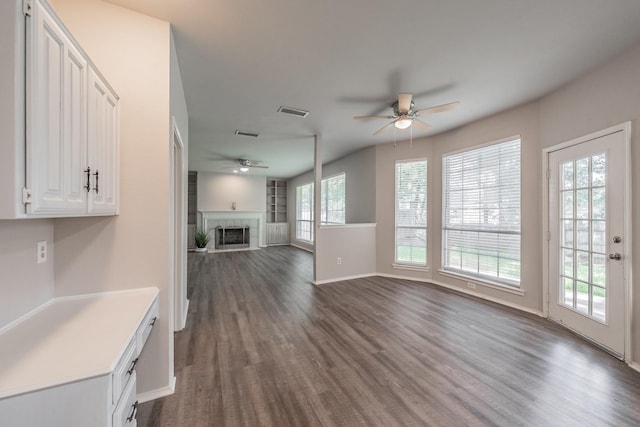1803 Haydenbend Cir, Grapevine, TX 76051 - unfurnished living room with a ceiling fan, a fireplace, dark wood-style flooring, and baseboards