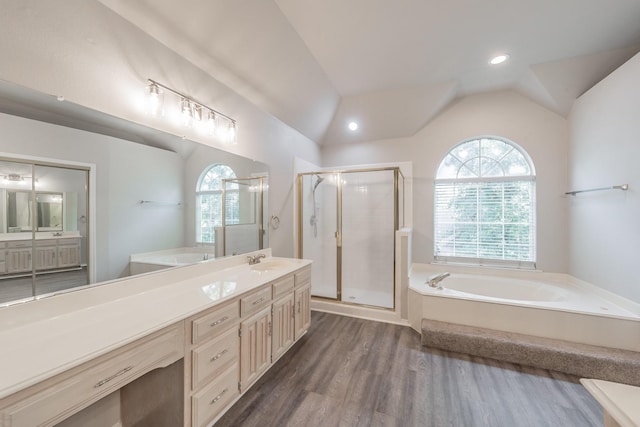 1803 Haydenbend Cir, Grapevine, TX 76051 - bathroom featuring lofted ceiling, a garden tub, vanity, a stall shower, and wood finished floors