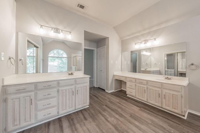 1803 Haydenbend Cir, Grapevine, TX 76051 - bathroom with lofted ceiling, wood finished floors, two vanities, and baseboards