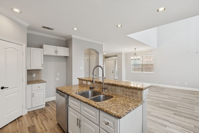 3711 Venice Dr, Irving, TX 75038 - kitchen with dishwasher, a sink, crown molding, white cabinetry, and arched walkways