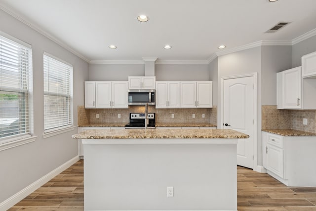 3711 Venice Dr, Irving, TX 75038 - kitchen featuring stainless steel appliances, light stone counters, decorative backsplash, light wood finished floors, and recessed lighting