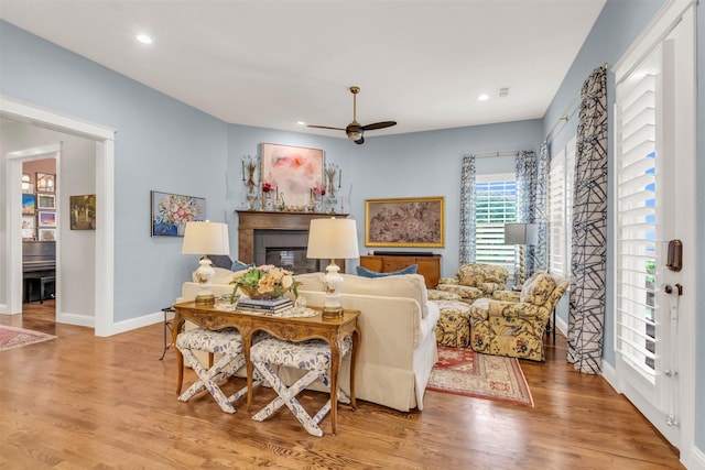 2116 Tremont Blvd, Mckinney, TX 75071 - living room with a glass covered fireplace, wood finished floors, ceiling fan, and recessed lighting