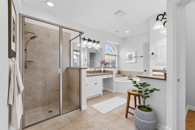 3436 Copper Point Ln, Frisco, TX 75034 - bathroom with vanity, a garden tub, a shower stall, tile patterned floors, and recessed lighting