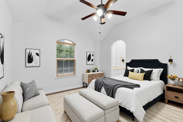 3436 Copper Point Ln, Frisco, TX 75034 - bedroom featuring arched walkways, wood finished floors, vaulted ceiling, baseboards, and a ceiling fan