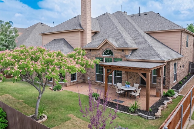 3436 Copper Point Ln, Frisco, TX 75034 - rear view of property featuring a patio, roof with shingles, brick siding, and a chimney