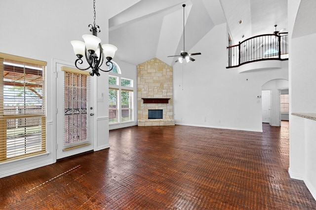 3436 Copper Point Ln, Frisco, TX 75034 - unfurnished living room featuring high vaulted ceiling, ceiling fan, a chandelier, arched walkways, and a stone fireplace