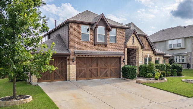 1925 Knoxbridge Rd, Forney, TX 75126 - view of front of home with a shingled roof, a front lawn, driveway, stone siding, and an attached garage