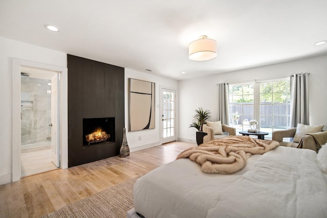 4336 Irvin Simmons Dr, Dallas, TX 75229 - bedroom with multiple windows, light wood finished floors, a fireplace, recessed lighting, and connected bathroom