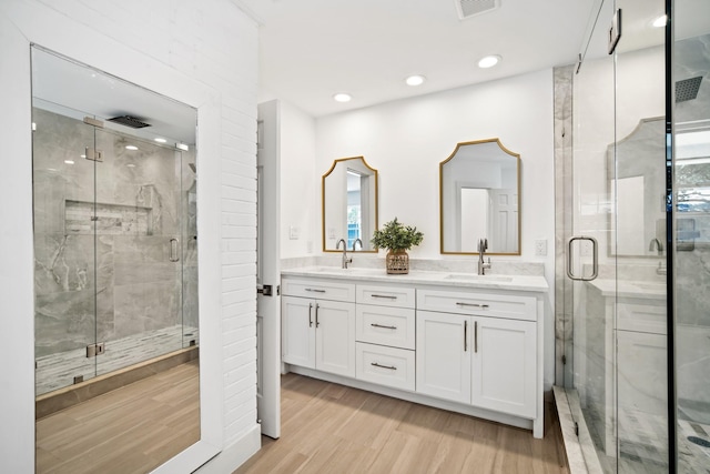 4336 Irvin Simmons Dr, Dallas, TX 75229 - full bath featuring wood finished floors, a stall shower, double vanity, and recessed lighting