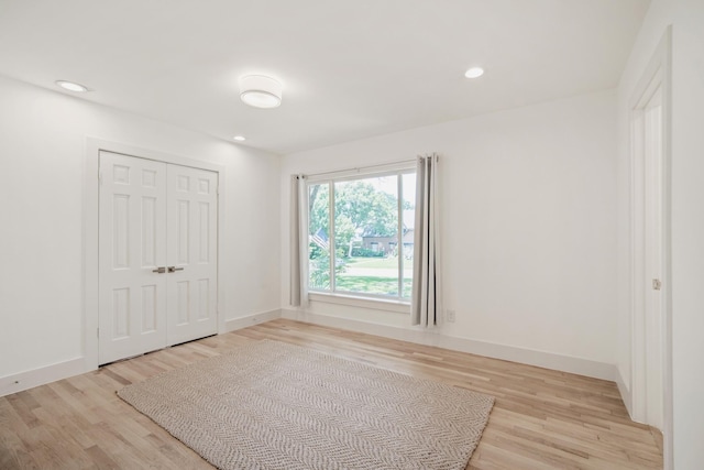 4336 Irvin Simmons Dr, Dallas, TX 75229 - unfurnished bedroom featuring light wood-type flooring, a closet, and recessed lighting