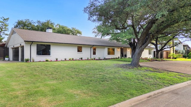 4336 Irvin Simmons Dr, Dallas, TX 75229 - ranch-style house featuring a chimney, a garage, a front lawn, driveway, and a shingled roof