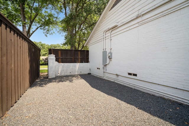 4336 Irvin Simmons Dr, Dallas, TX 75229 - view of side of home featuring a gate, crawl space, and brick siding