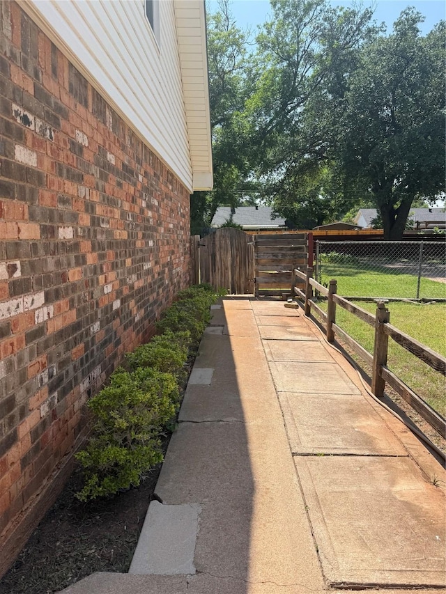 2050 Greenbriar Dr, Abilene, TX 79605 - view of side of property with brick siding and a gate