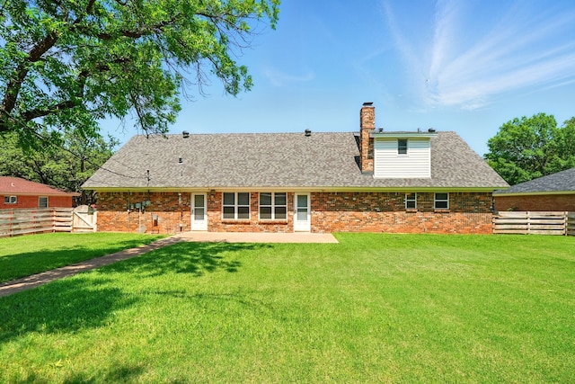 2050 Greenbriar Dr, Abilene, TX 79605 - rear view of property featuring a chimney, a shingled roof, a patio, and brick siding