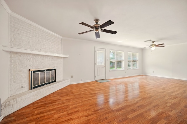 2050 Greenbriar Dr, Abilene, TX 79605 - unfurnished living room featuring a ceiling fan, light wood-type flooring, ornamental molding, baseboards, and a fireplace