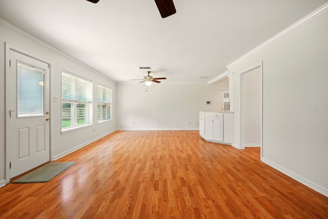 2050 Greenbriar Dr, Abilene, TX 79605 - unfurnished living room with a ceiling fan, ornamental molding, light wood-style flooring, and baseboards
