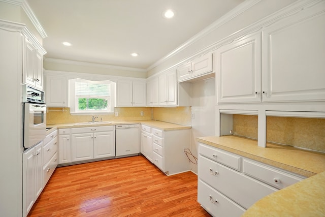 2050 Greenbriar Dr, Abilene, TX 79605 - kitchen with dishwasher, ornamental molding, oven, white cabinetry, and tasteful backsplash