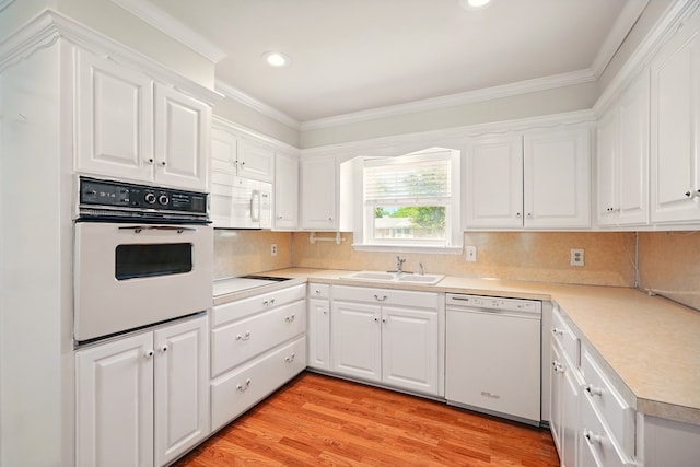 2050 Greenbriar Dr, Abilene, TX 79605 - kitchen featuring white appliances, a sink, ornamental molding, white cabinetry, and light countertops