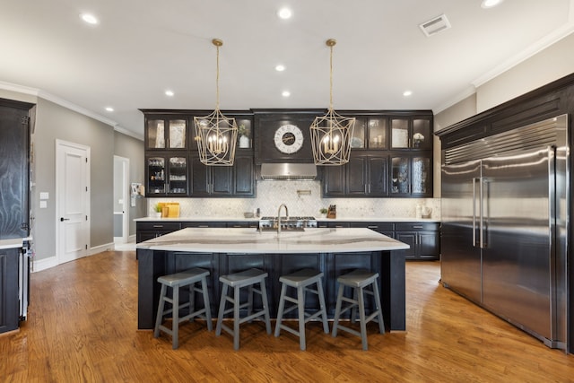 400 Whitley Place Dr, Prosper, TX 75078 - kitchen featuring built in refrigerator, a chandelier, crown molding, exhaust hood, and a large island with sink