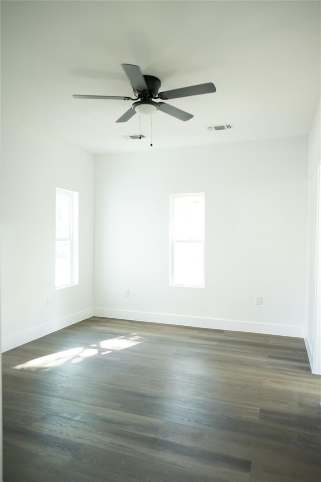 309 E Cheek St, Saint Jo, TX 76265 - spare room with baseboards, ceiling fan, and dark wood finished floors