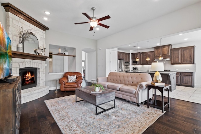 350 Lake Trail Ln, Prosper, TX 75078 - living area with a ceiling fan, arched walkways, a fireplace, light wood-style floors, and recessed lighting