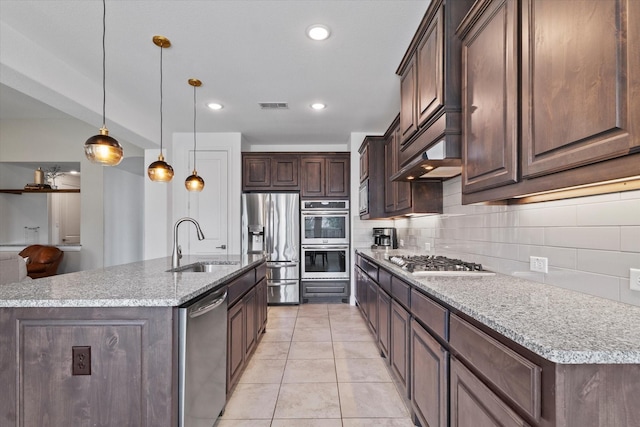 350 Lake Trail Ln, Prosper, TX 75078 - kitchen featuring appliances with stainless steel finishes, backsplash, a sink, dark brown cabinets, and light tile patterned flooring