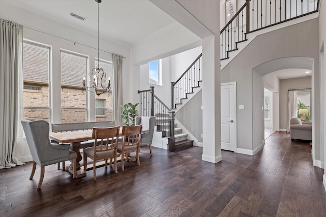 350 Lake Trail Ln, Prosper, TX 75078 - dining area featuring arched walkways, stairway, a chandelier, dark wood finished floors, and baseboards