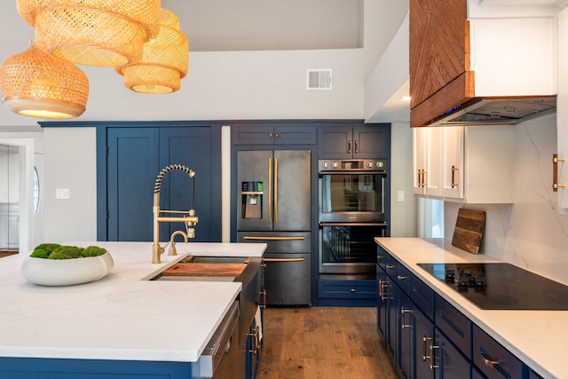 5325 Seascape Ln, Plano, TX 75093 - kitchen featuring fridge with ice dispenser, black electric cooktop, double wall oven, custom range hood, and blue cabinets