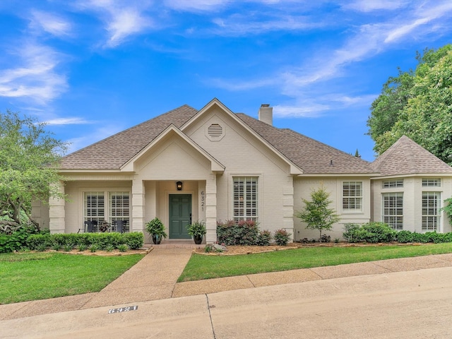 6321 Fershaw Pl, Fort Worth, TX 76116 - view of front of home featuring a chimney, a shingled roof, brick siding, and a front lawn