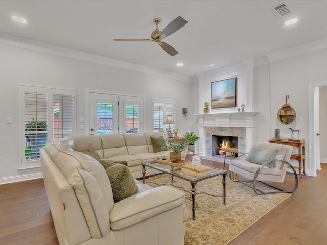 6321 Fershaw Pl, Fort Worth, TX 76116 - living area featuring crown molding, ceiling fan, wood finished floors, a tiled fireplace, and baseboards