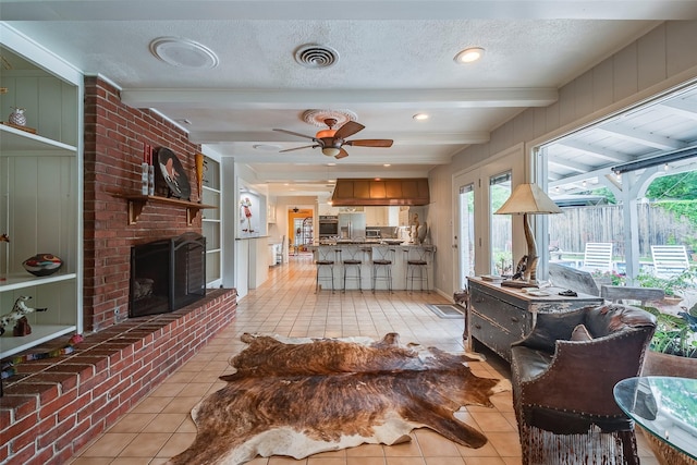 4141 Shannon Dr, Fort Worth, TX 76116 - living room with light tile patterned flooring, ceiling fan, healthy amount of natural light, a fireplace, and beamed ceiling