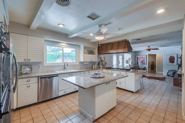 4141 Shannon Dr, Fort Worth, TX 76116 - kitchen featuring stainless steel appliances, a sink, ceiling fan, a peninsula, and beamed ceiling