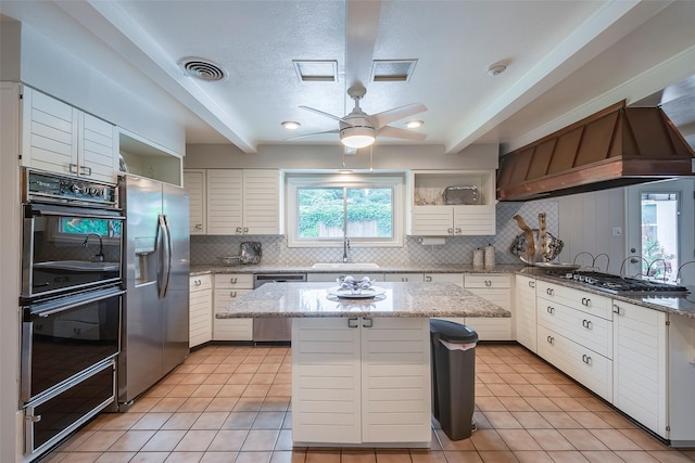 4141 Shannon Dr, Fort Worth, TX 76116 - kitchen featuring stainless steel appliances, a sink, open shelves, tasteful backsplash, and custom exhaust hood