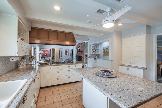 4141 Shannon Dr, Fort Worth, TX 76116 - kitchen with a ceiling fan, a center island, white cabinets, and beamed ceiling