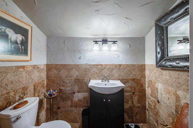 4141 Shannon Dr, Fort Worth, TX 76116 - half bath with tile walls, toilet, vanity, and a wainscoted wall