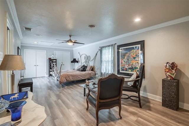 4141 Shannon Dr, Fort Worth, TX 76116 - bedroom featuring crown molding, light wood finished floors, two closets, baseboards, and a ceiling fan