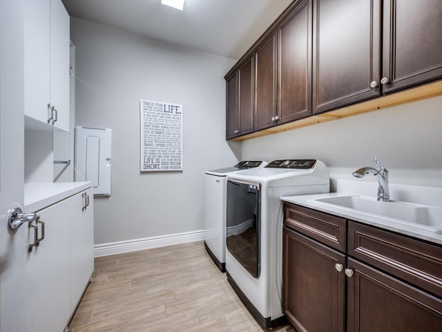 9813 Ironwood Dr, Denton, TX 76207 - laundry area featuring cabinet space, washer and dryer, baseboards, and light wood-style floors