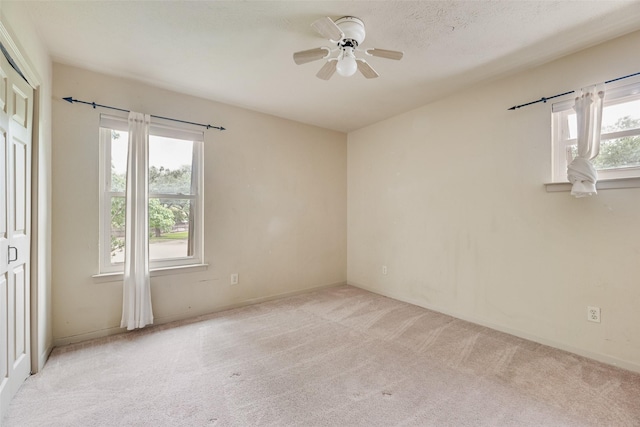 4 Waterview Pl, Richardson, TX 75080 - empty room with light colored carpet, plenty of natural light, ceiling fan, and baseboards