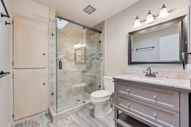 4 Waterview Pl, Richardson, TX 75080 - bathroom featuring toilet, wood finished floors, vanity, and a shower stall