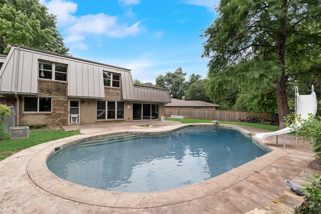 4 Waterview Pl, Richardson, TX 75080 - view of swimming pool with a water slide, a fenced backyard, and a patio