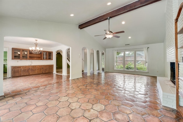 4 Waterview Pl, Richardson, TX 75080 - unfurnished living room featuring a fireplace, ceiling fan, a chandelier, arched walkways, and a sink