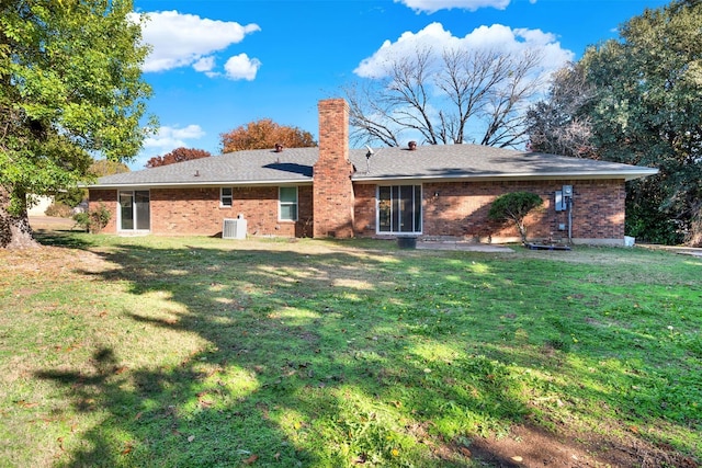 413 Shadowwood Trl, Ovilla, TX 75154 - back of property featuring central air condition unit, a lawn, a chimney, and brick siding