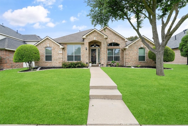 3540 Mason Dr, Plano, TX 75025 - view of front of property featuring brick siding, a front yard, and roof with shingles