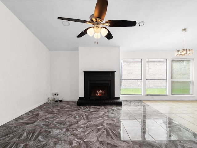 1640 Lemonwood Cir, Mesquite, TX 75149 - unfurnished living room featuring a warm lit fireplace, ceiling fan, a chandelier, baseboards, and marble finish flooring