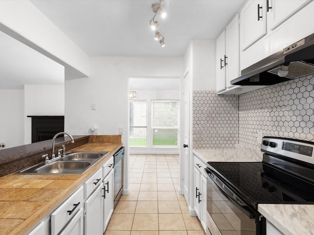 1640 Lemonwood Cir, Mesquite, TX 75149 - kitchen with stainless steel appliances, a sink, under cabinet range hood, light tile patterned floors, and white cabinetry