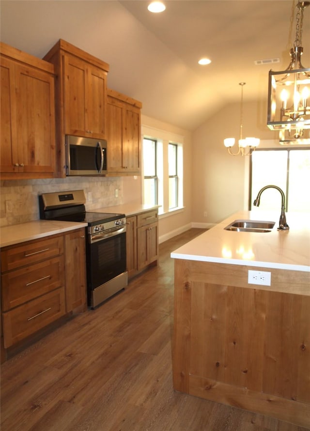 701 Raylan St, Springtown, TX 76082 - kitchen featuring appliances with stainless steel finishes, a sink, a chandelier, vaulted ceiling, and tasteful backsplash