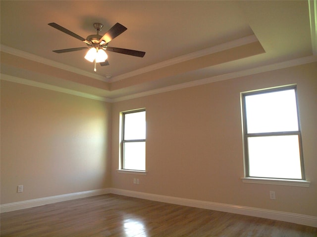 701 Raylan St, Springtown, TX 76082 - empty room featuring a raised ceiling, light wood-style floors, ornamental molding, a ceiling fan, and baseboards