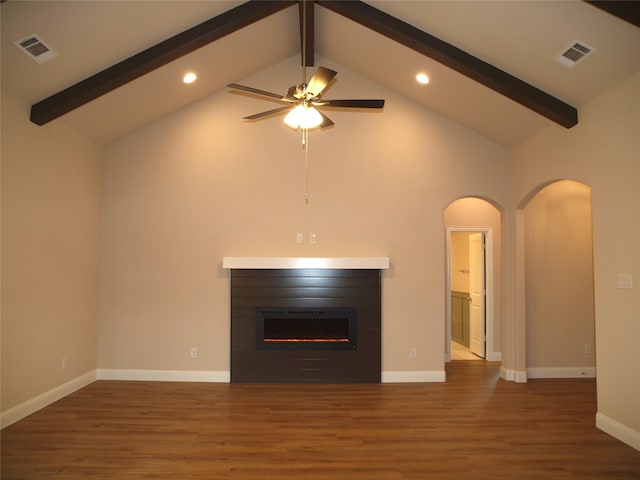 701 Raylan St, Springtown, TX 76082 - unfurnished living room with beam ceiling, arched walkways, wood finished floors, high vaulted ceiling, and recessed lighting