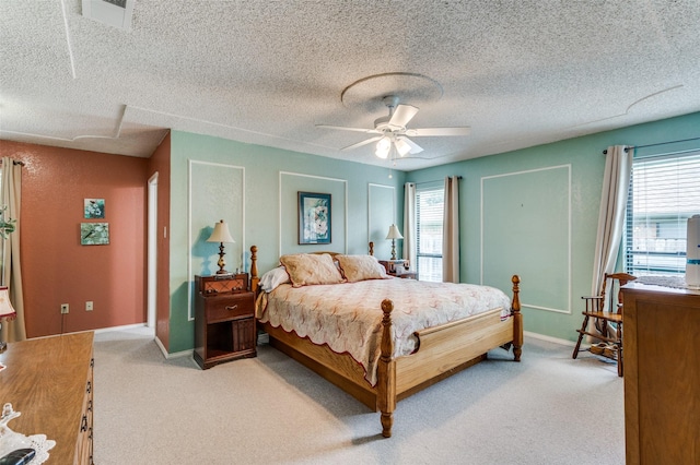 1001 Woodhaven Ct, Euless, TX 76039 - bedroom with multiple windows, light colored carpet, ceiling fan, baseboards, and a textured ceiling