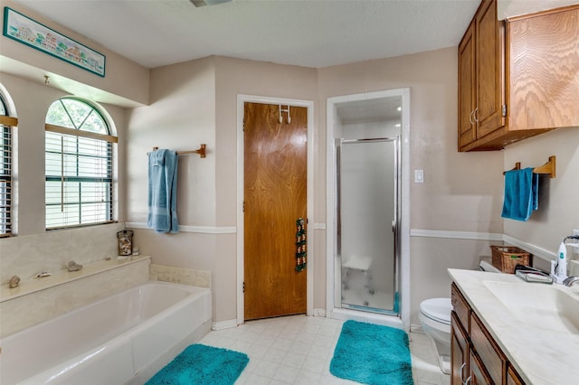 1001 Woodhaven Ct, Euless, TX 76039 - bathroom featuring a stall shower, toilet, vanity, and a garden tub